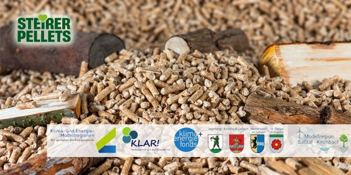 An image of a pile of wood pellets, the logo of 'Steirer Pellets' is visible in the upper left corner, and there is a white label with the logo of 'KLIMA+energie Modellregionen' and the text 'KLAR!' in the lower right corner.