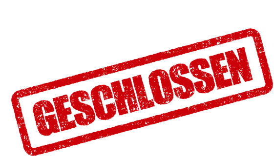 Ein roter Stempel mit dem Wort 'Geschlossen' in fetter, großgeschriebener deutscher Schrift. Der Stempel scheint aus Gummi oder Kunststoff zu sein.