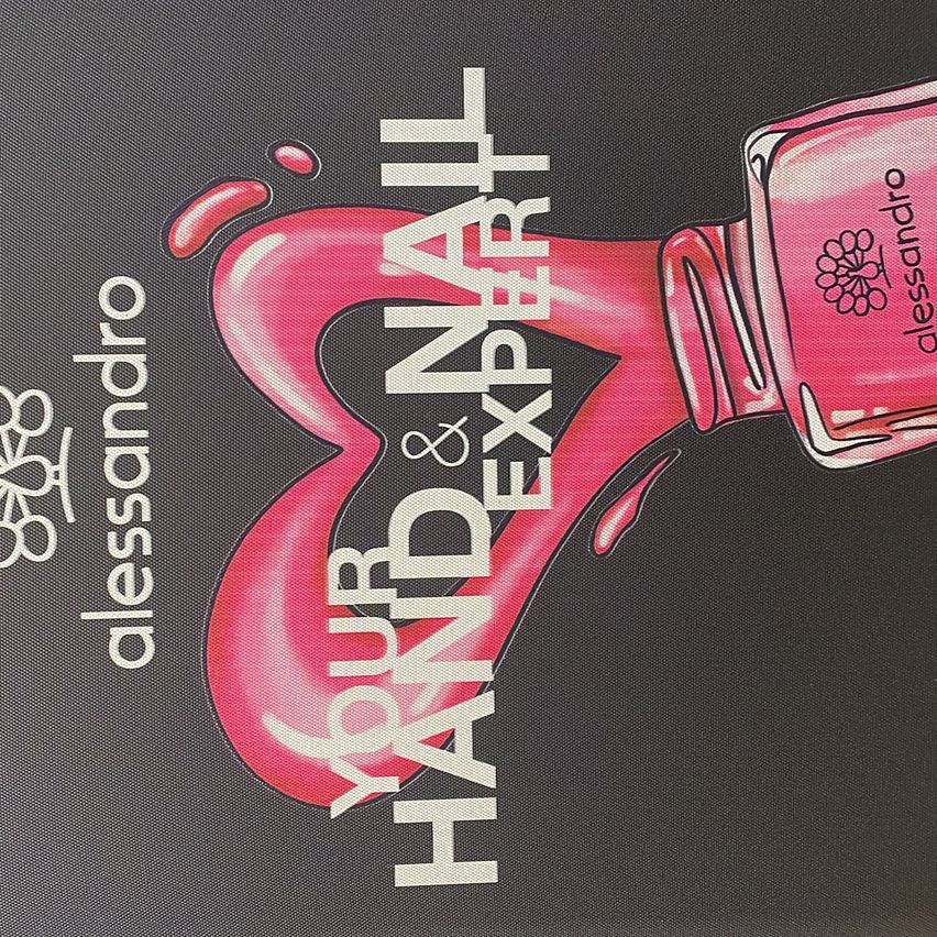 A pink nail polish bottle with the brand name 'alessandro' is shown on a black background. The bottle is depicted as if it is being poured into a heart shape. The text reads 'Your Hand & Nail Expert'.