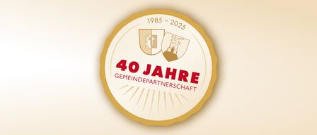 Logo für 40 Jahre Gemeindepartnerschaft, mit zwei Wappen und den Jahren 1985 bis 2025.