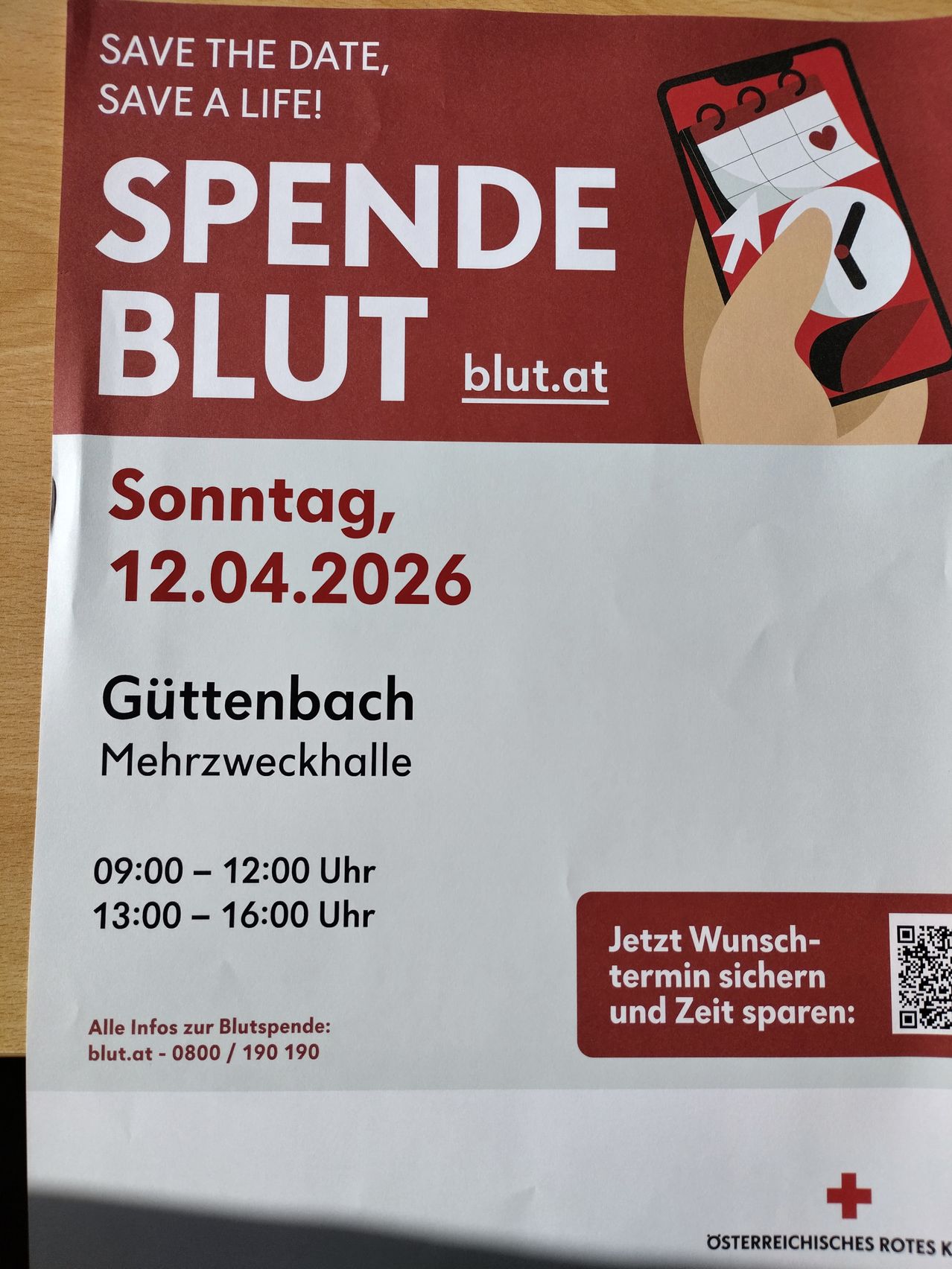 Blood donation event on Sunday, April 12, 2026 at Guttenbach Multi-Purpose Hall. Times: 09:00-12:00 and 13:00-16:00. Visit blut.at for more information. QR code for appointment booking.