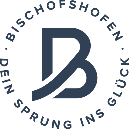Ein blaues 'B'-Symbol umgeben von der Phrase 'Dein Sprung ins Glück' auf schwarzem Hintergrund.