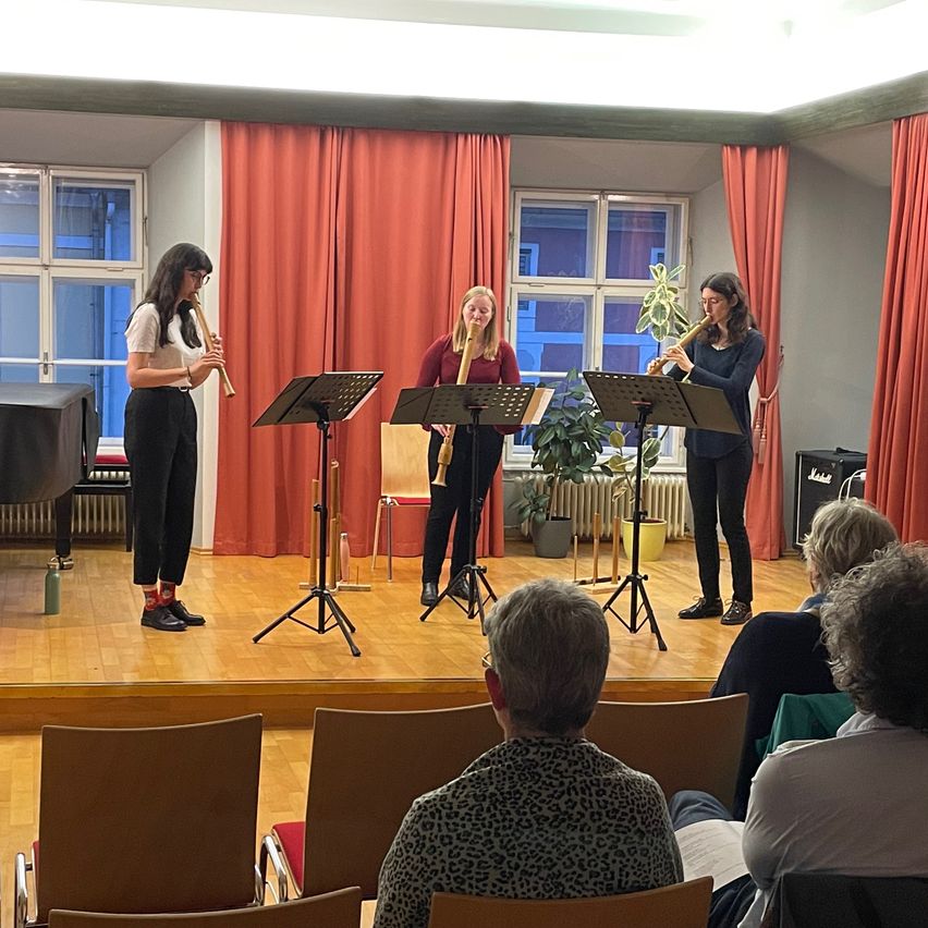 Bild enthält, Crowd, Person, Shoe, Audience, Chair, Glasses, Speaker, Speech, Debate, Violin