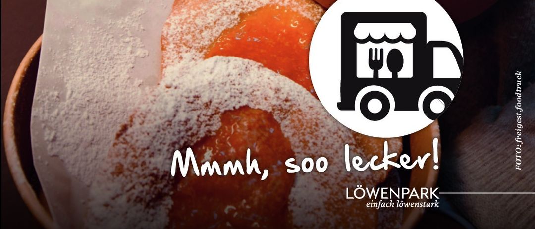 Bild eines Gebäcks, das mit Puderzucker bestreut ist. In der Ecke befindet sich ein LKW-Logo mit der Aufschrift 'Mmmh, soo lecker!' und 'Löwenpark-einfach lowenstark.'