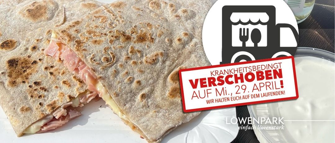 Ein Bild von einem Burrito mit Schinken und Käse. Rechts steht ein Schild, das 'Krankheitsbedingt verschoben' sagt. Darunter steht 'AUF MI., 29. APRIL!' und 'Wir halten euch auf dem Laufenden.' Oben ist ein Logo.
