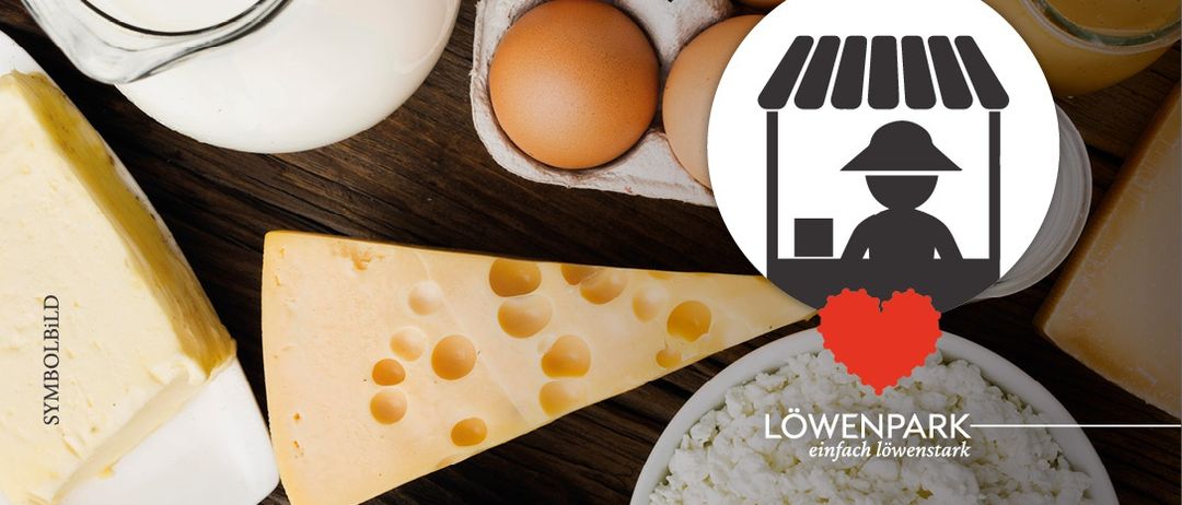 Auf einem Holztisch sind Käse, Eier, Milch und Reis mit einem Ladensymbol und dem Text 'Löwenpark' zu sehen.