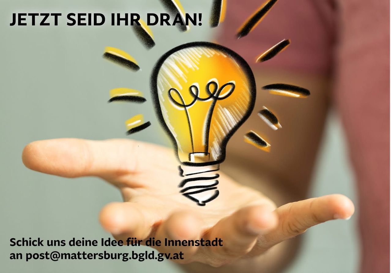 Eine Hand hält eine leuchtende Glühbirne mit dem Slogan 'Seid Ihre eigene Idee für die Innenstadt'.