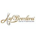 Das Logo für Auf Brezlerei, ein Friseursalon, zeigt einen stilisierten Buchstaben 'A' mit einer Schleife und den Worten 'Deine Frisierstub' in Gold auf weißem Hintergrund.