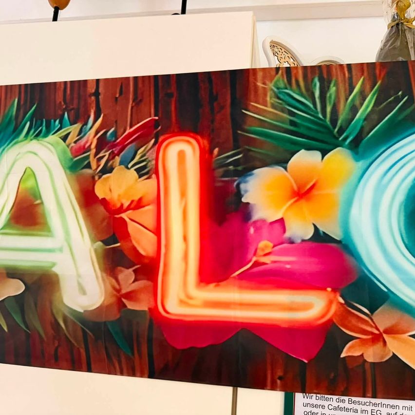 A vibrant neon sign with the letters A and L in red and white, surrounded by colorful tropical flowers and leaves on a wooden background.