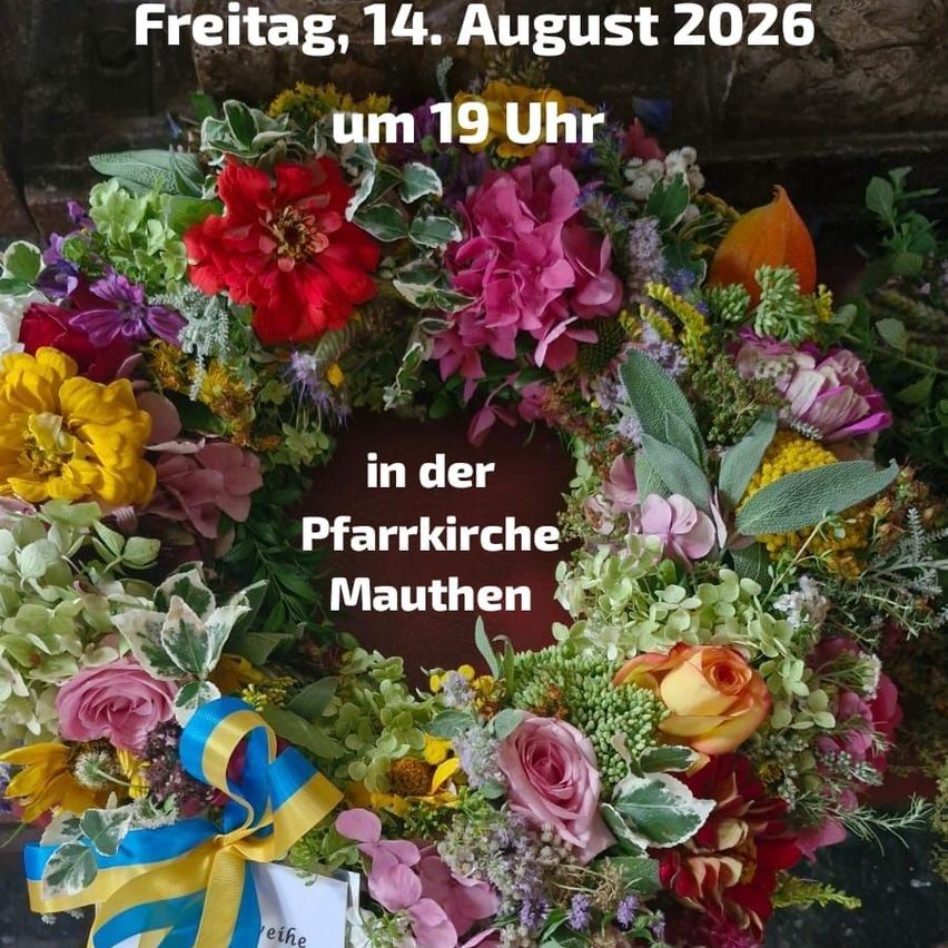 A wreath of colorful flowers with a blue and yellow ribbon, set against a brick background. The text reads 'Freitag, 14. August 2026 um 19 Uhr in der Pfarrkirche Mauthen'.
