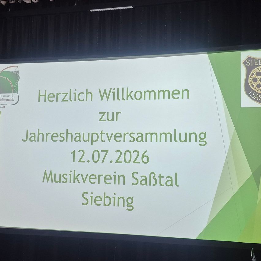 A presentation slide on a projector screen welcomes attendees to the annual meeting of the Sabtal Music Association on July 12, 2026.