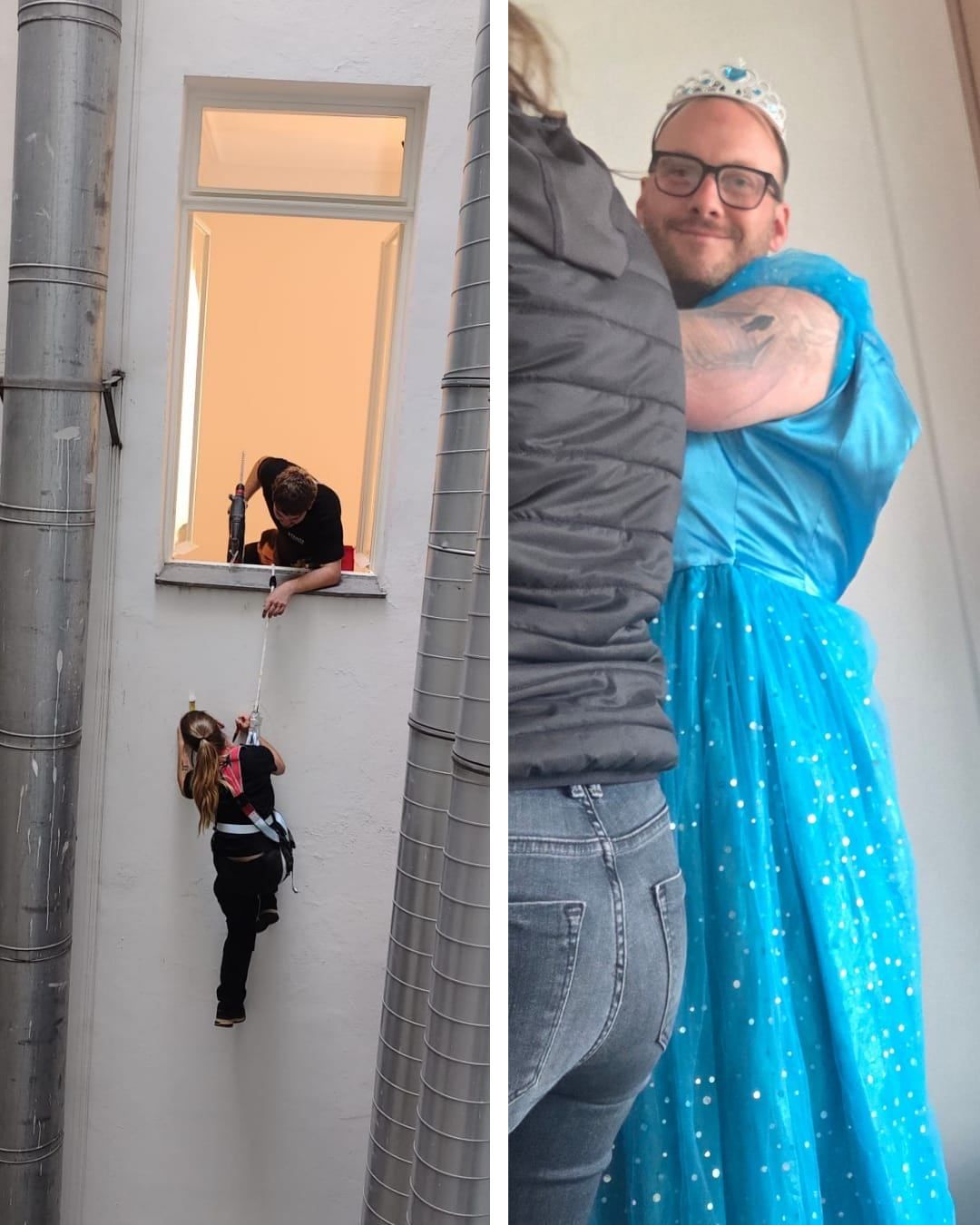 Eine Person klettert mit Gurt und Seil an einer Wand, während eine andere Person ein Fenster mit einer Bohrmaschine repariert.