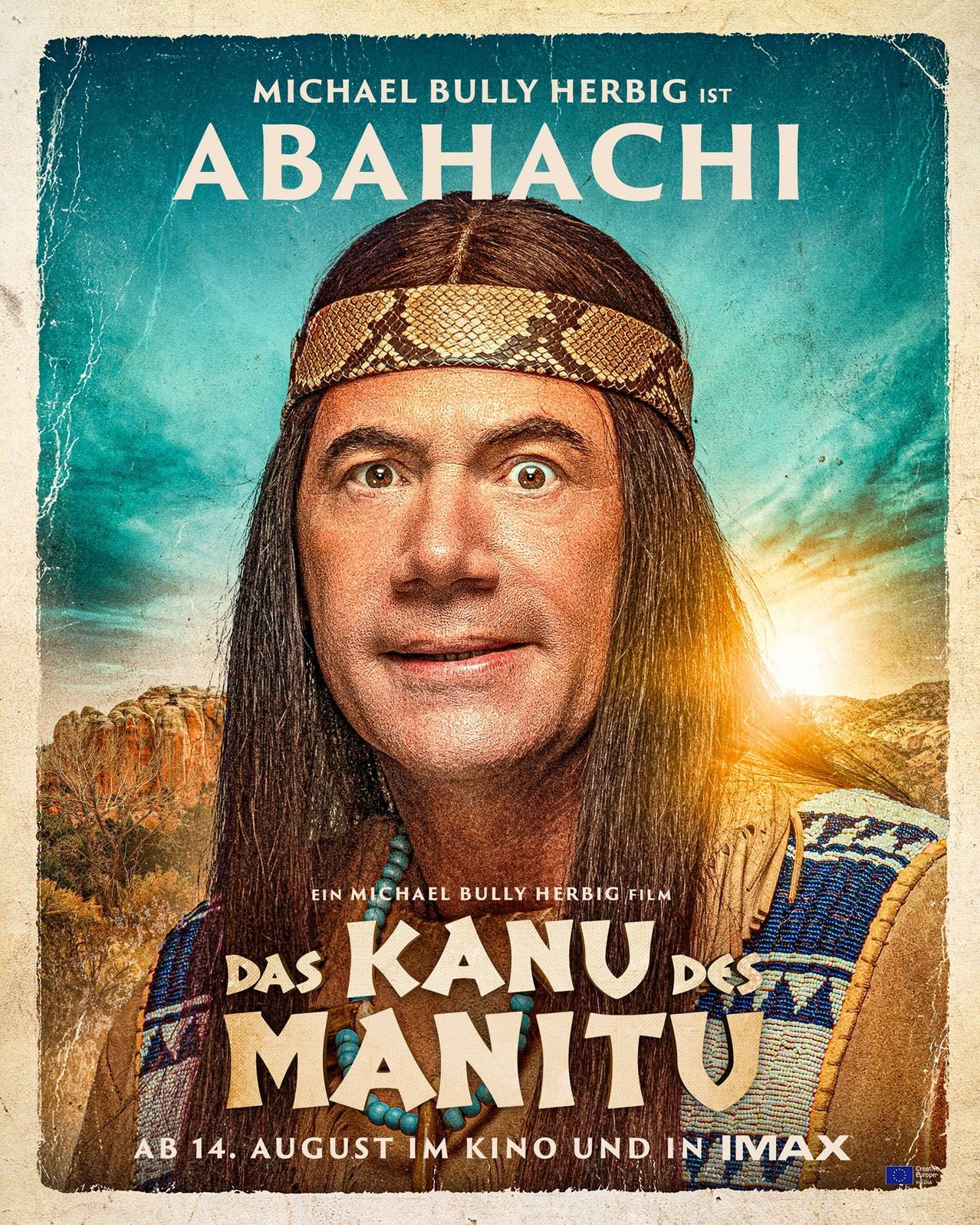 Filmplakat für die Komödie 'Das Kanu des Manitu' mit einem Mann in indianischer Kleidung, der in die Kamera lächelt.