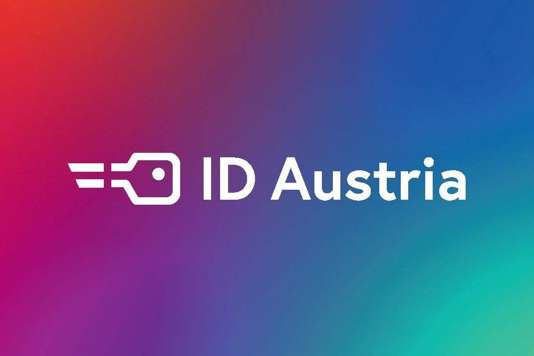 ID Austria Logo mit einem farbenfrohen Gradientenhintergrund und einem Schlüsselsymbol auf der linken Seite.