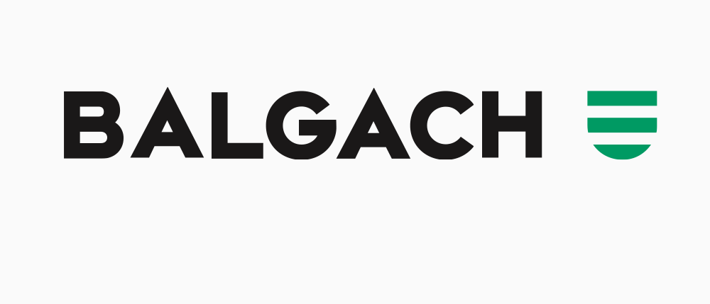 Das Balgach-Logo erscheint auf weißem Hintergrund mit fettem schwarzen Text und einem grünen Symbol rechts.