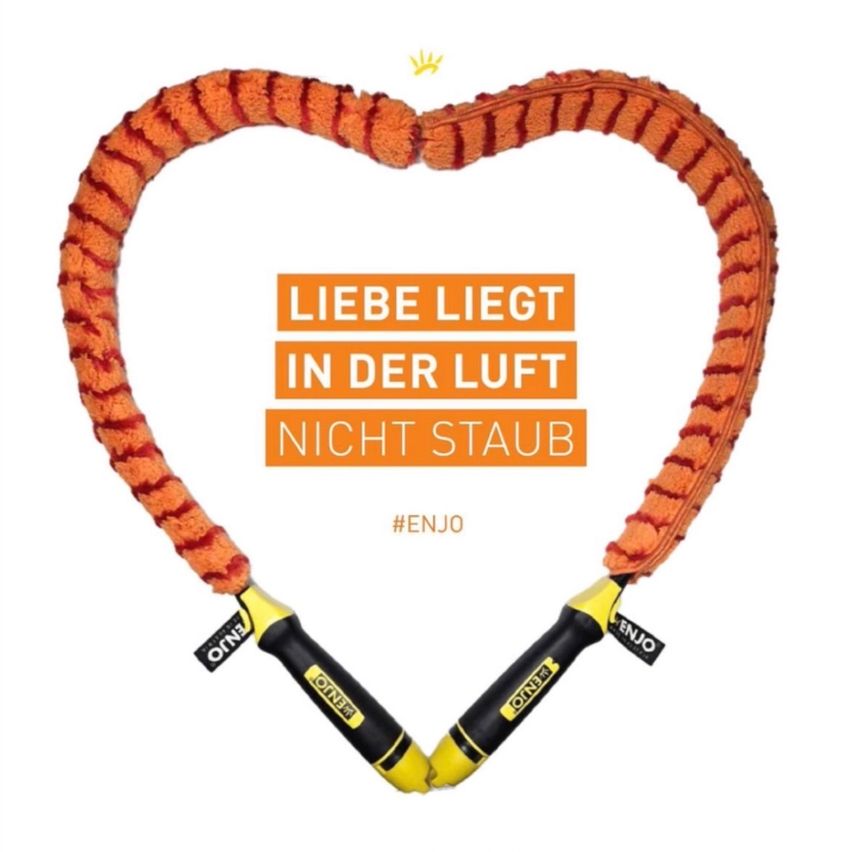 A heart-shaped rope in orange and yellow colors with a slogan 'Love is in the air, not dust' and a hashtag #ENJO.