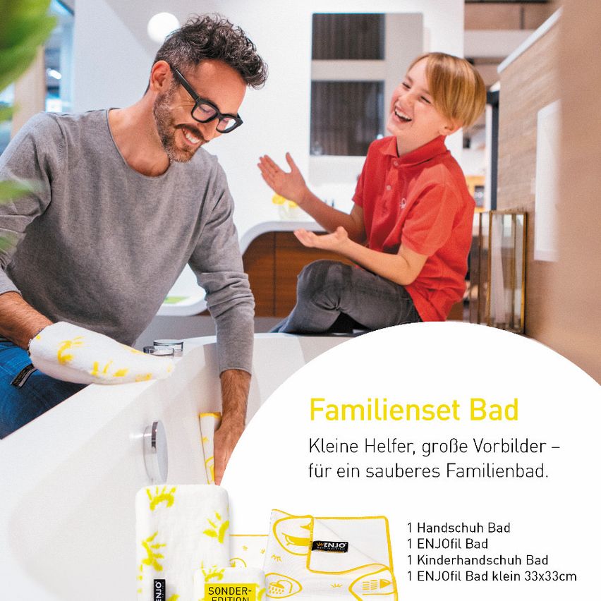 A man and a boy are smiling and playing in a bathroom. The man is standing in a bathtub with gloves on, and the boy is sitting on the edge of the bathtub. The image also includes a product advertisement for a family bath set.