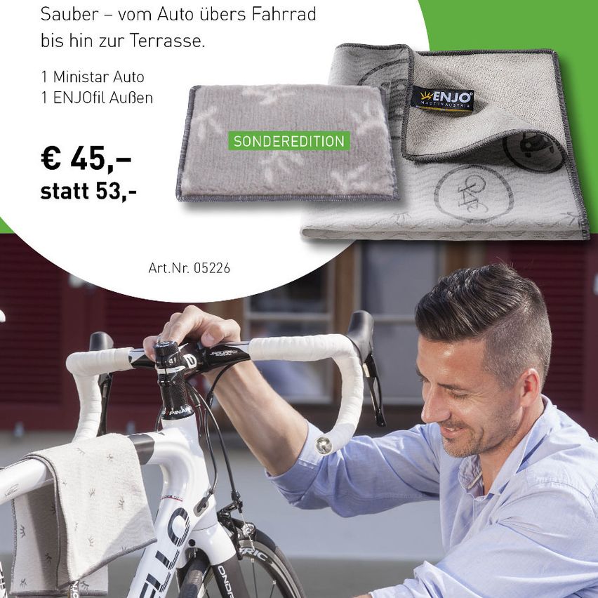 An advertisement for a special edition ENJO microfiber cleaning cloth, showing a man cleaning a bicycle. The offer includes one mini car cleaner and one ENJO oil for 45 instead of 53 euros. Article number 05226.