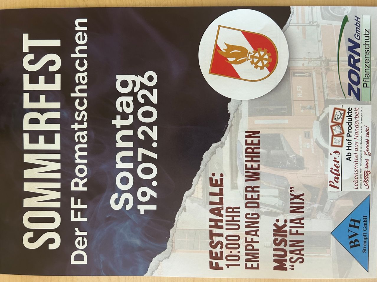 Poster for the 'Sommerfest' event on July 19, 2026, featuring a logo with a flame and gear, and a partially torn background with a building and machinery.