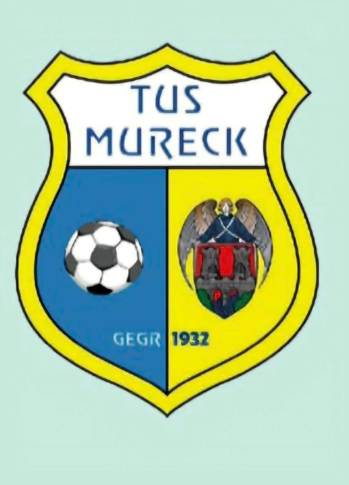 The emblem of Tus Mureck, featuring a soccer ball, an angel, and a coat of arms with the year 1932.