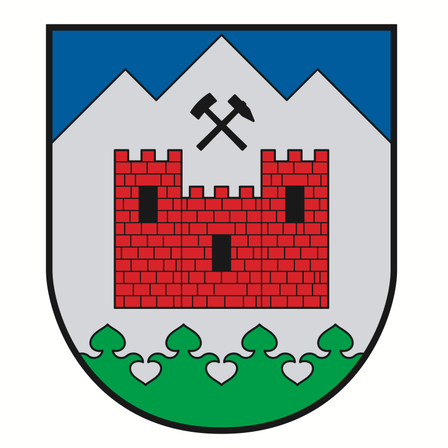 Ein Schild mit einer roten Burg und einem Hammer auf einem Berg, umgeben von einem grünen Rand.