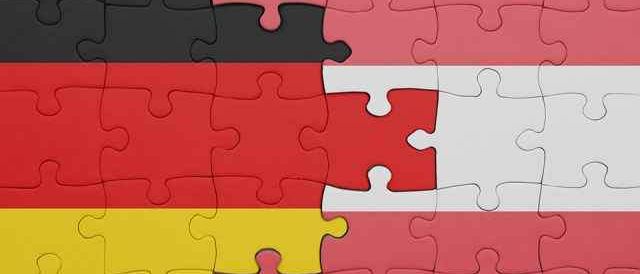 Ein Puzzle, das die deutsche Flagge in drei verschiedene Abschnitte unterteilt, wobei der untere Teil gelb, der mittlere Teil rot und der obere Teil schwarz ist.
