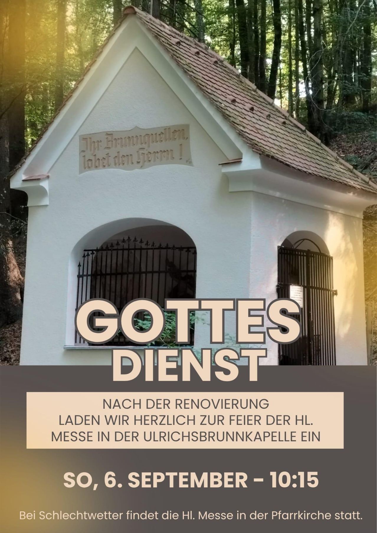 A small white chapel with a brown roof and black gates. It has a sign that reads 'Gottes Dienst' and a plaque with a German inscription. The chapel is surrounded by trees.