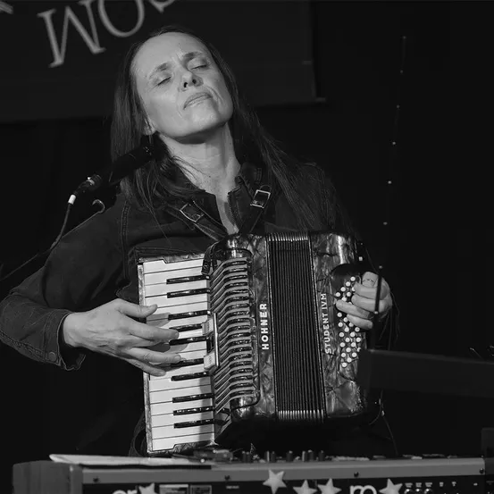 Adult, Female, Person, Woman, Musical Instrument, Face, Electrical Device, Microphone, Solo Performance, Accordion