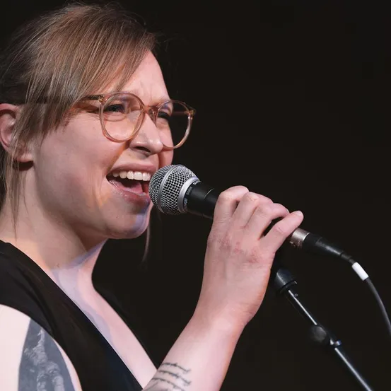 Microphone, Person, Solo Performance, Adult, Female, Woman, Finger, Glasses, Face, Head