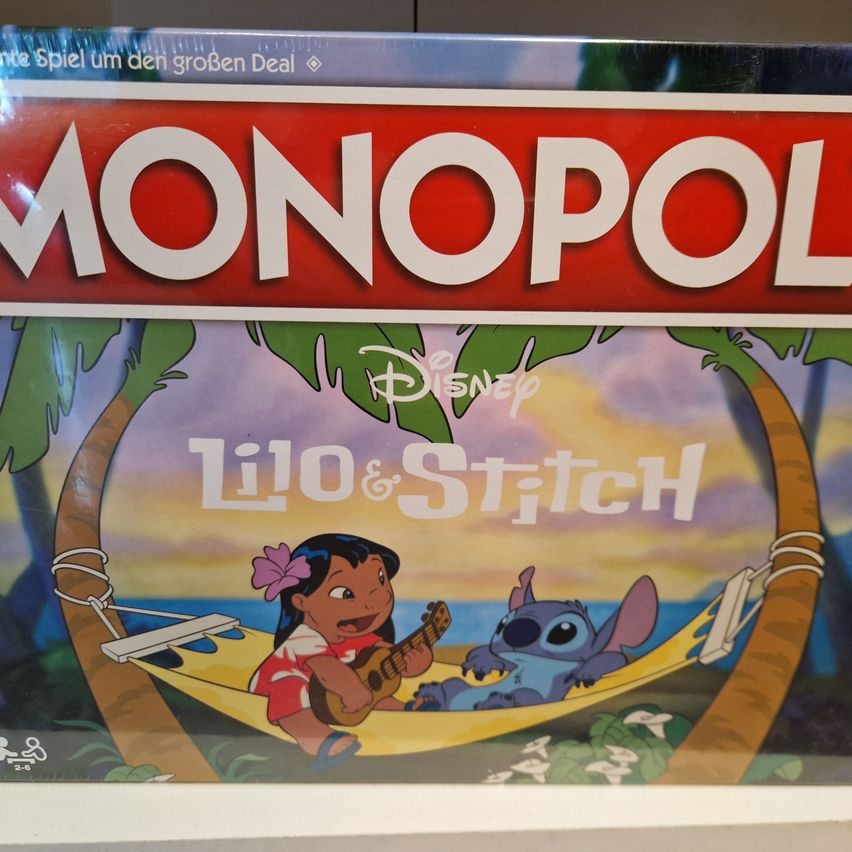 A board game titled Monopoly featuring the Disney characters Lilo and Stitch relaxing on a hammock under a palm tree.