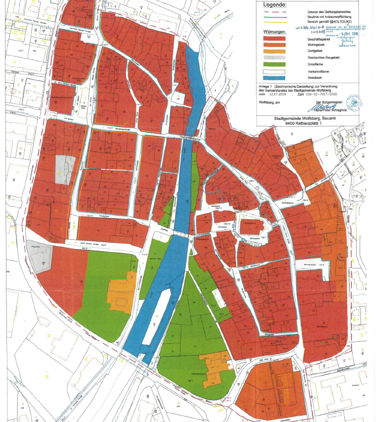 Eine Karte von Wolfsberg mit verschiedenen farbigen Bereichen, die unterschiedliche Zonentypen darstellen, einschließlich Wohn-, Gewerbe- und Industriezonen. Die Karte ist vom 2. Dezember 2019 und vom Bürgermeister unterzeichnet.