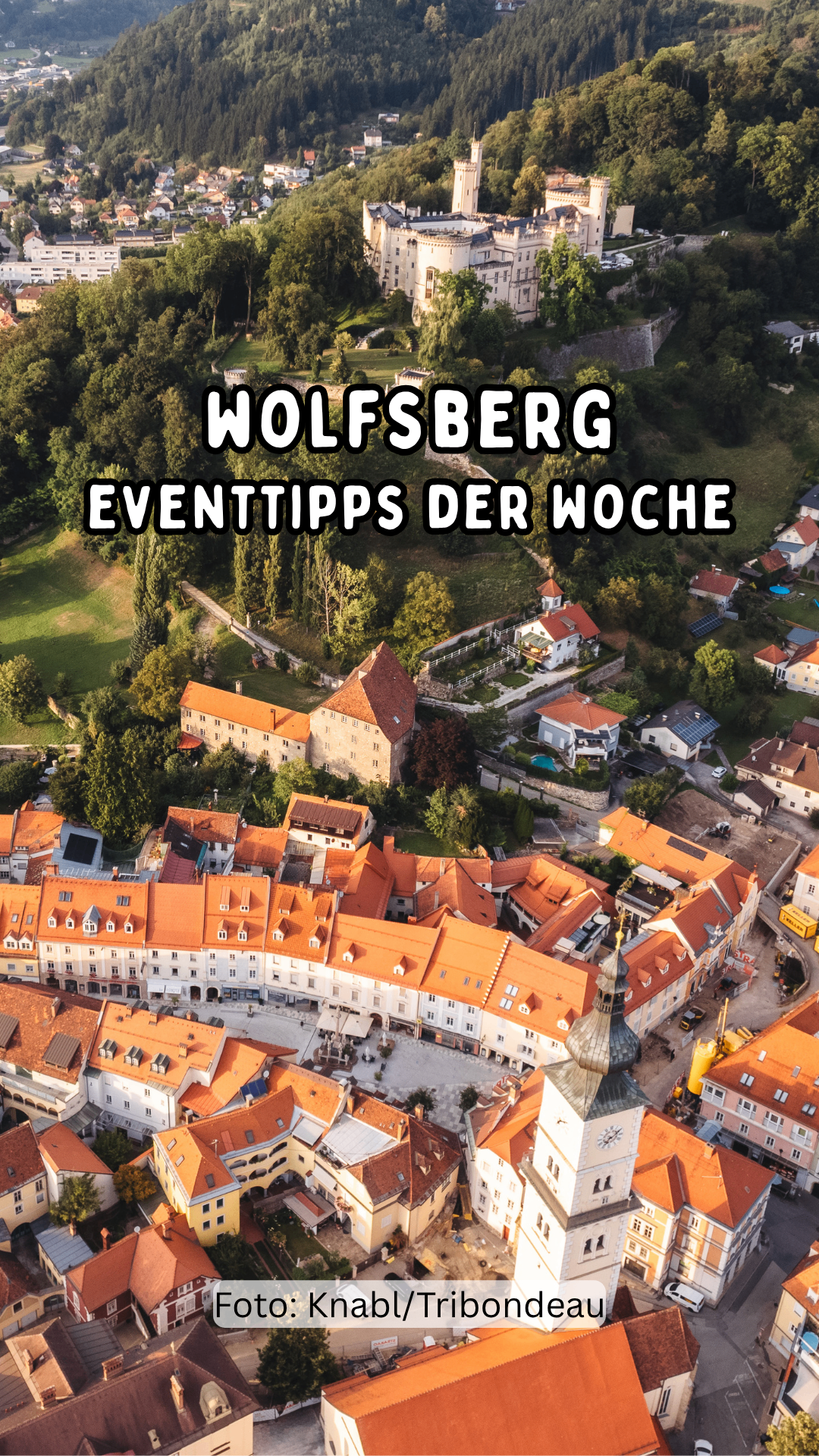 An aerial view of the town of Wolfsberg with orange rooftops and the text 'Wolfsberg Eventtipps der Woche' in white.