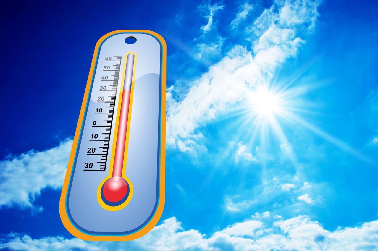 A thermometer with a red liquid indicating a temperature of 30 degrees Celsius against a blue sky with clouds and a shining sun.