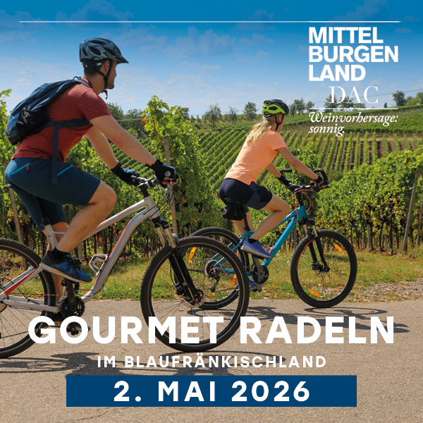 Two cyclists in helmets ride through vineyards. A sign reads Gourmet Radeln im Blaufränkischland. Date: May 2, 2026.