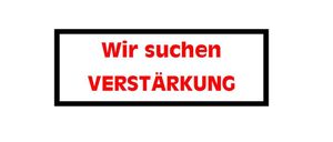 Ein weißes Schild mit schwarzem Rand zeigt roten Text, der 'Wir suchen VERSTARKUNG' lautet. Der Text ist fett und großgeschrieben.
