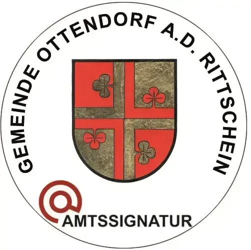 Offizielles Logo der Gemeinde Ottendorf A.D. Ritschschein, mit einem kreisförmigen Emblem, einem roten und goldenen Schild, vier Kleeblättern und dem Text "AmtssignaTur" darunter.
