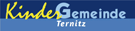 Ein blauer Banner mit weißem Text, der 'KinderGemeine Ternitz' lautet. Das Wort 'Kinder' ist gelb und 'Gemeine' ist blau, während 'Ternitz' weiß ist.