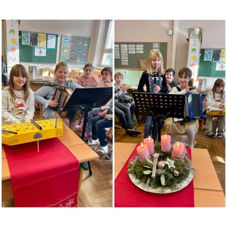 Kinder in einem Klassenzimmer spielen Musikinstrumente, eines spielt Akkordeon und ein anderes Flöte. Ein Kerzenkranz steht auf dem Schreibtisch.