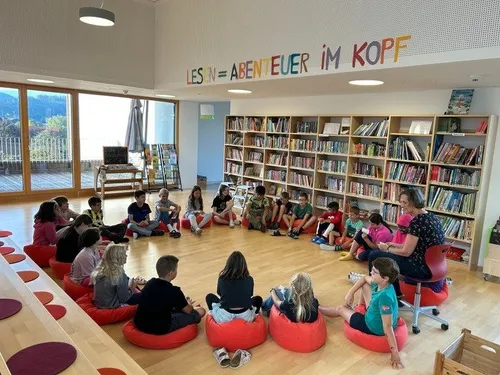 Library, Adult, Female, Person, Woman, Furniture, Hat, Shoe, Chair, People