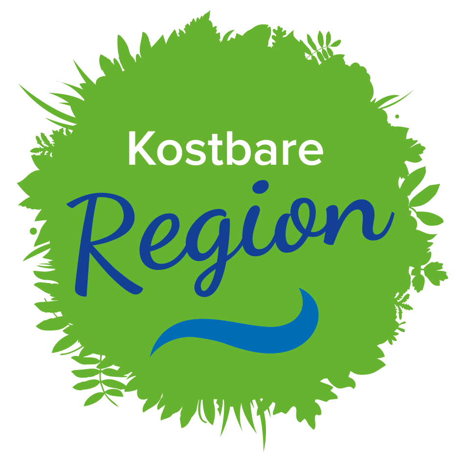 Ein kreisförmiges Logo für Kostbare Region, mit grünen Blättern und einem blauen Wellendesign. Der Text 'Kostbare Region' steht in weiß.
