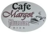 Ein Schild für Cafe Margot Flurnuer, mit einer Kaffeetasse und einem Buch, in ovaler Form.