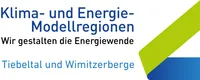Das Bild mit dem Titel 'Klima- und Energie-Modellregionen' zeigt blaue und grüne Farben. Es hebt Regionen wie Tiebeltal und Wimitzerberge hervor und zeigt ihre Rolle bei der Energiewende.