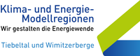 Das Bild mit dem Titel 'Klima- und Energie-Modellregionen' zeigt blaue und grüne Farben. Es hebt Regionen wie Tiebeltal und Wimitzerberge hervor und zeigt ihre Rolle bei der Energiewende.