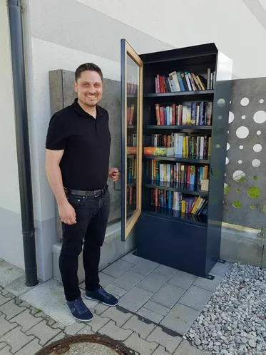 Furniture, Person, Standing, Pants, Adult, Male, Man, Bookcase, Belt, Jeans