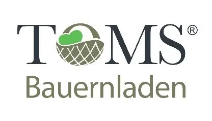 Das Logo für TOMS Bauernladen zeigt einen Korb mit einem Herzen darin und den Text 'TOMS' in fetter, schwarzer Schrift mit einem kleinen 'R'-Symbol am Ende. Darunter steht das Wort 'Bauernladen' in einer leichteren, grauen Schrift.