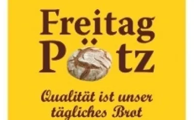 Ein gelbes Plakat zeigt die Worte Freitag Potz mit einem goldbraunen Brotlaib in der Mitte. Darunter steht: Qualität ist unser tägliches Brot.