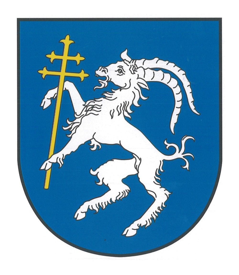 Ein blauer Schild mit einem weißen Widder, der einen goldenen Kreuz in seinem Maul hält und auf einem Bein steht.