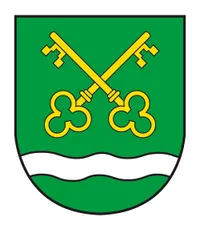 Ein grüner Schild mit einer weißen Wellenlinie am unteren Rand und zwei gelben Schlüsseln, die sich darüber kreuzen.