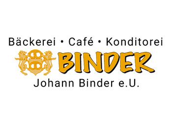 Das Logo von Binder Johann Binder e.U. zeigt einen goldenen Löwenwappen über dem Wort Binder, mit Backerei, Cafe und Konditorei in einer geschwungenen Linie darüber.