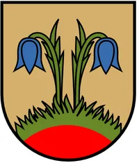 Ein Schild mit goldenem Hintergrund, das zwei blaue Blumen auf grünen Stielen über einer roten Basis zeigt.